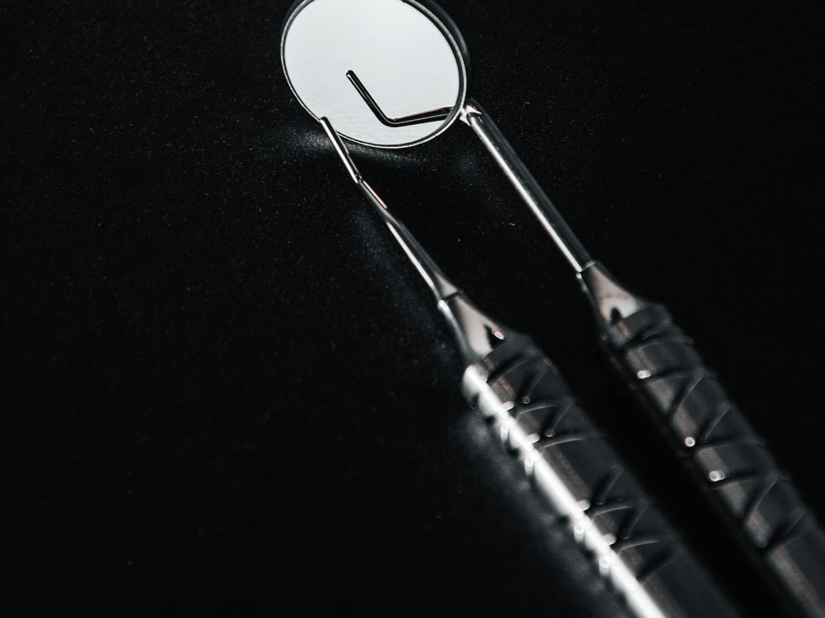 AJ Brothers polished stainless-steel instruments arranged on a sterile cloth